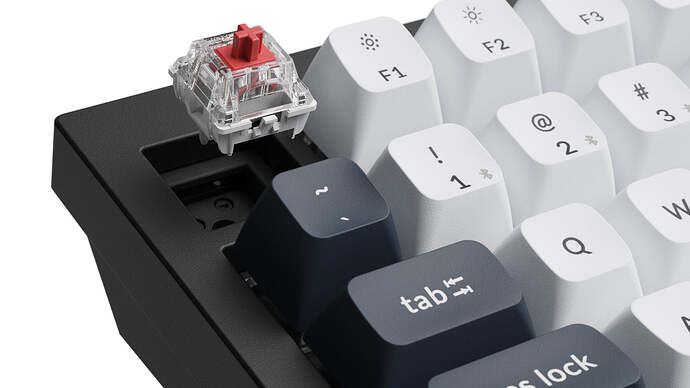 Gateron Jupiter Red switch lifted out of the hot swap socket on a Keychron Q6 Max