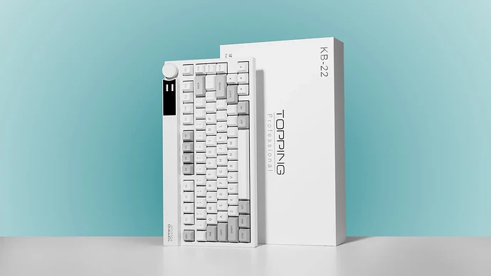 TOPPING KB22 keyboard with its rotary knob and colour display beside the white KB-22 retail box